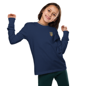 Youth in navy long sleeve shirt with golden Ukrainian Trizub design, soft cotton, crew neck, ribbed cuffs, cultural pride clothing.
