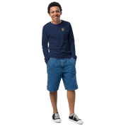 Youth wearing long sleeve shirt with golden Ukrainian Trizub on chest, styled with denim shorts and sneakers.