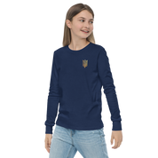 Youth wearing navy long sleeve shirt with golden Ukrainian Trizub on heart, showcasing heritage and style.