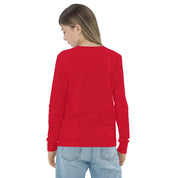 Youth wearing red long sleeve tee, back view, showcasing comfortable fit and soft Airlume cotton fabric.