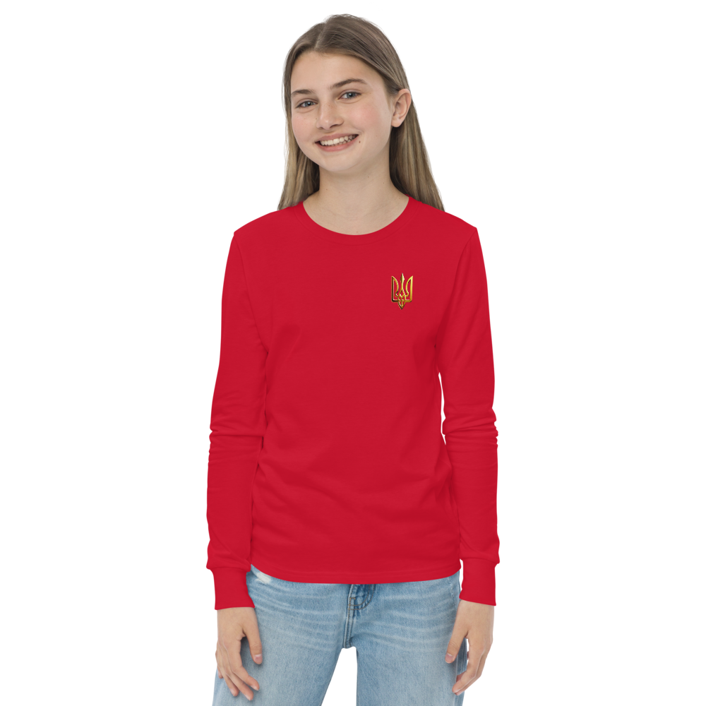 Youth in red long sleeve shirt with golden Ukrainian Trizub on heart area, showcasing heritage and style.