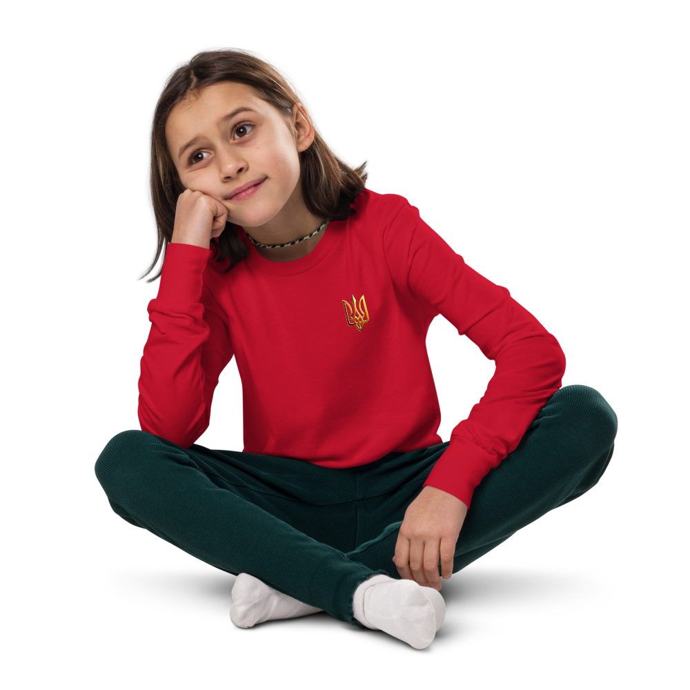 Youth long sleeve shirt with gold Ukrainian Trizub on heart, worn by a child.