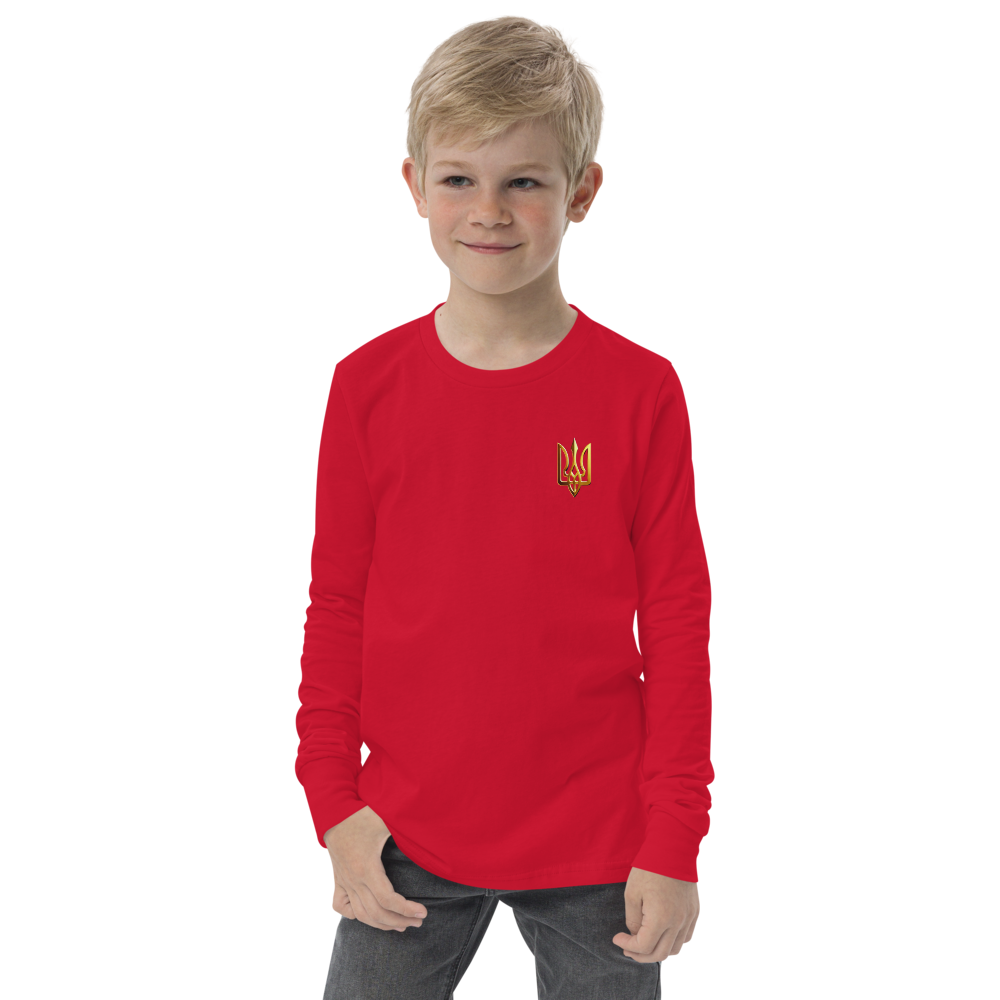 Youth long sleeve shirt with golden Ukrainian Trizub on heart, red color, worn by a young boy, showcasing heritage and style.