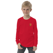 Youth long sleeve shirt with golden Ukrainian Trizub on heart, red color, worn by a young boy, showcasing heritage and style.