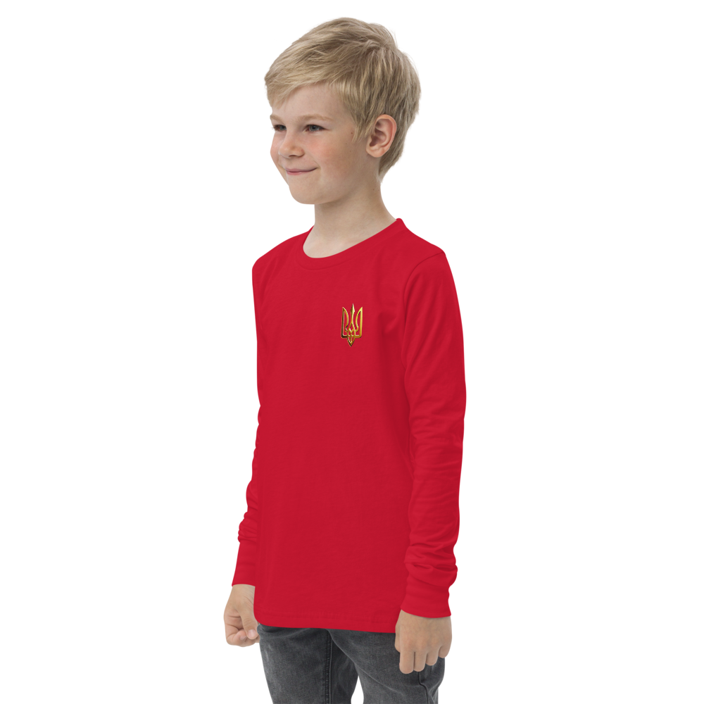 Youth wearing red long sleeve shirt with golden Ukrainian Trizub, standing in casual pose, displaying heritage pride.