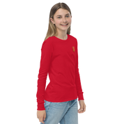 Youth wearing red long sleeve shirt with golden Ukrainian Trizub on the heart, showcasing cultural pride and casual style.