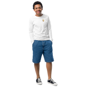 Youth wearing a white long sleeve shirt with Ukrainian Trizub on left chest, paired with denim shorts and sneakers.