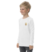 Youth wearing white long sleeve shirt with golden Ukrainian Trizub on the heart, showcasing heritage pride and casual style.