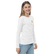 Youth wearing long sleeve shirt with golden Ukrainian Trizub on heart, showcasing heritage.
