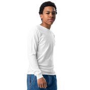 Youth in white long sleeve shirt with golden Ukrainian Trizub design, showcasing heritage pride.