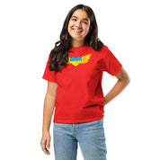 Youth wearing red t-shirt featuring Ukrainian Tryzub emblem, showcasing cultural pride and heritage.