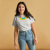 Youth wearing a classic t-shirt with Ukrainian Tryzub emblem, showcasing national pride; ideal for active kids. 100% cotton comfort.
