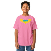 Youth wearing pink t-shirt featuring Ukrainian Tryzub emblem in vibrant colors, showcasing cultural pride and comfort.
