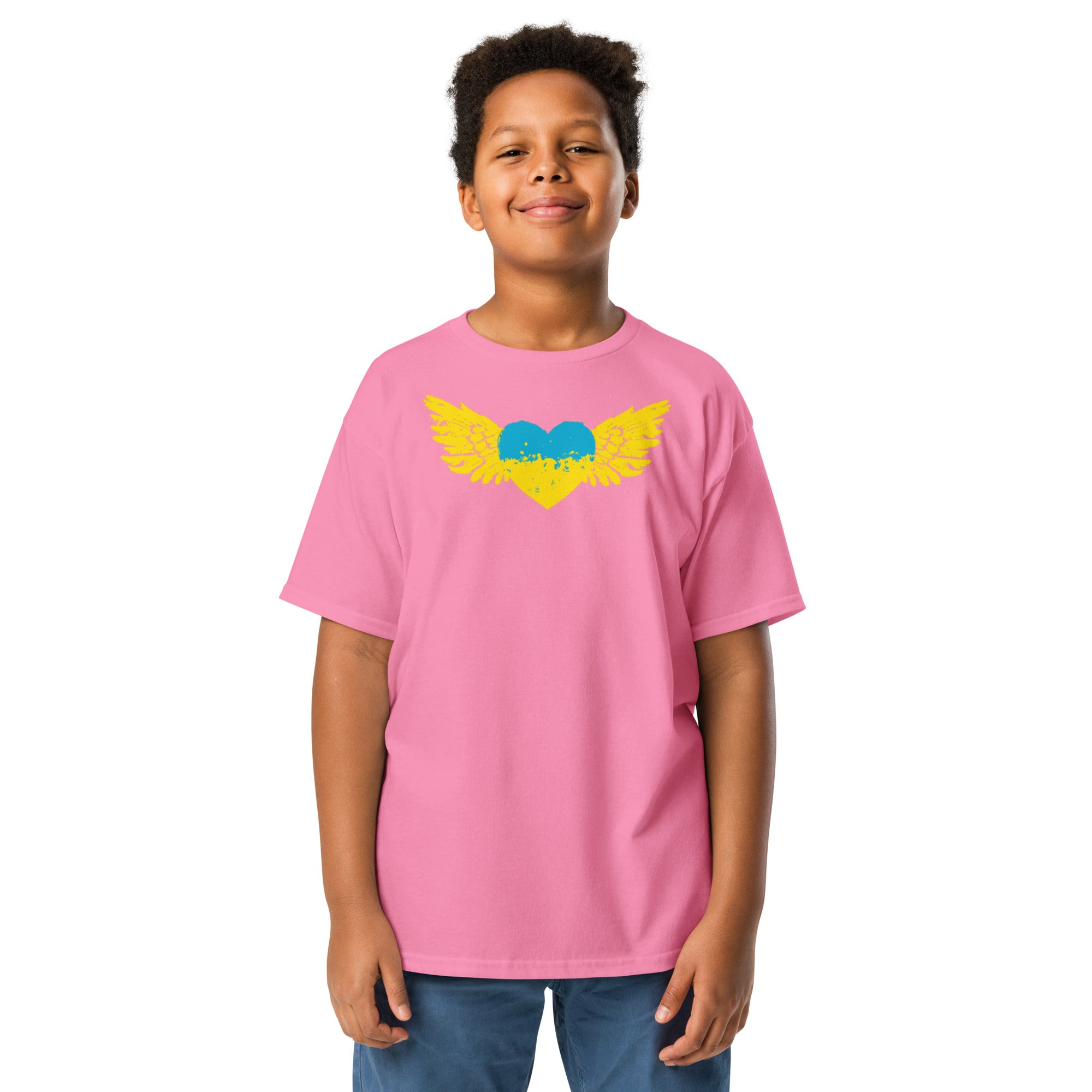 Youth wearing pink t-shirt featuring Ukrainian Tryzub emblem in vibrant colors, showcasing cultural pride and comfort.