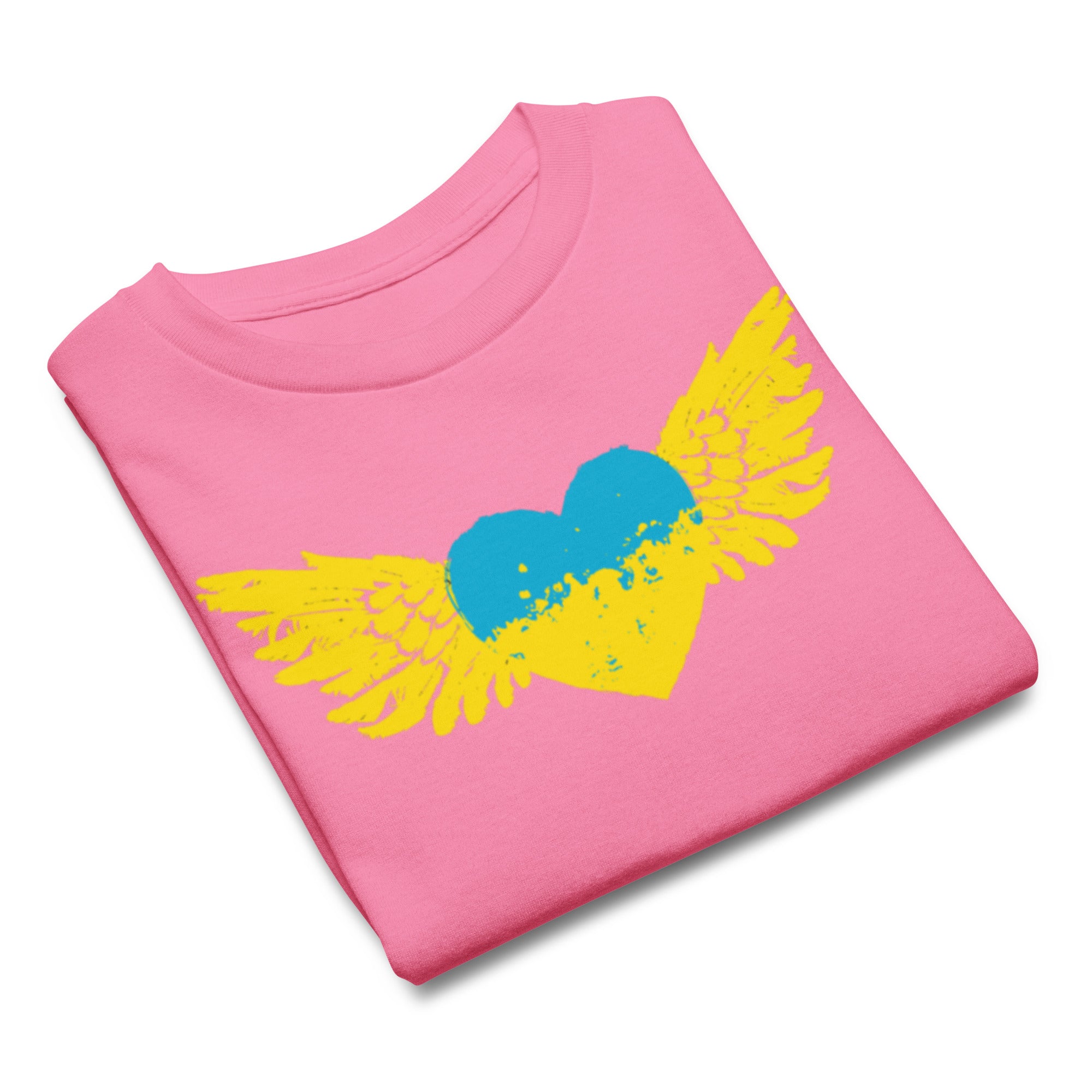 Folded pink t-shirt with a yellow and blue heart with wings graphic, symbolizing freedom and pride.