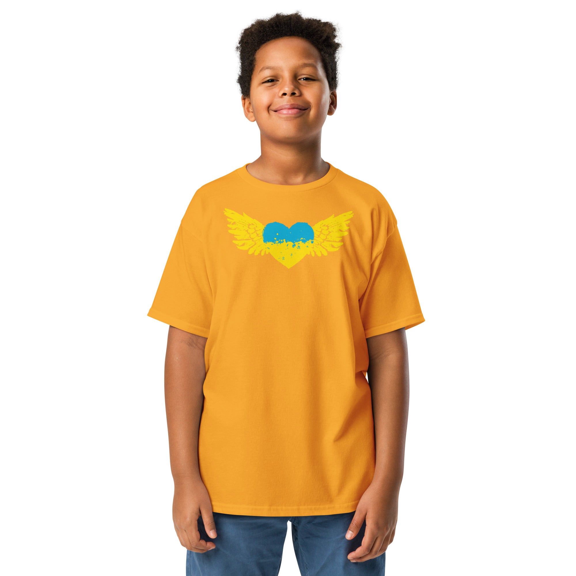 Youth wearing a bright orange T-shirt with a Ukrainian winged heart design, showcasing cultural pride and style.